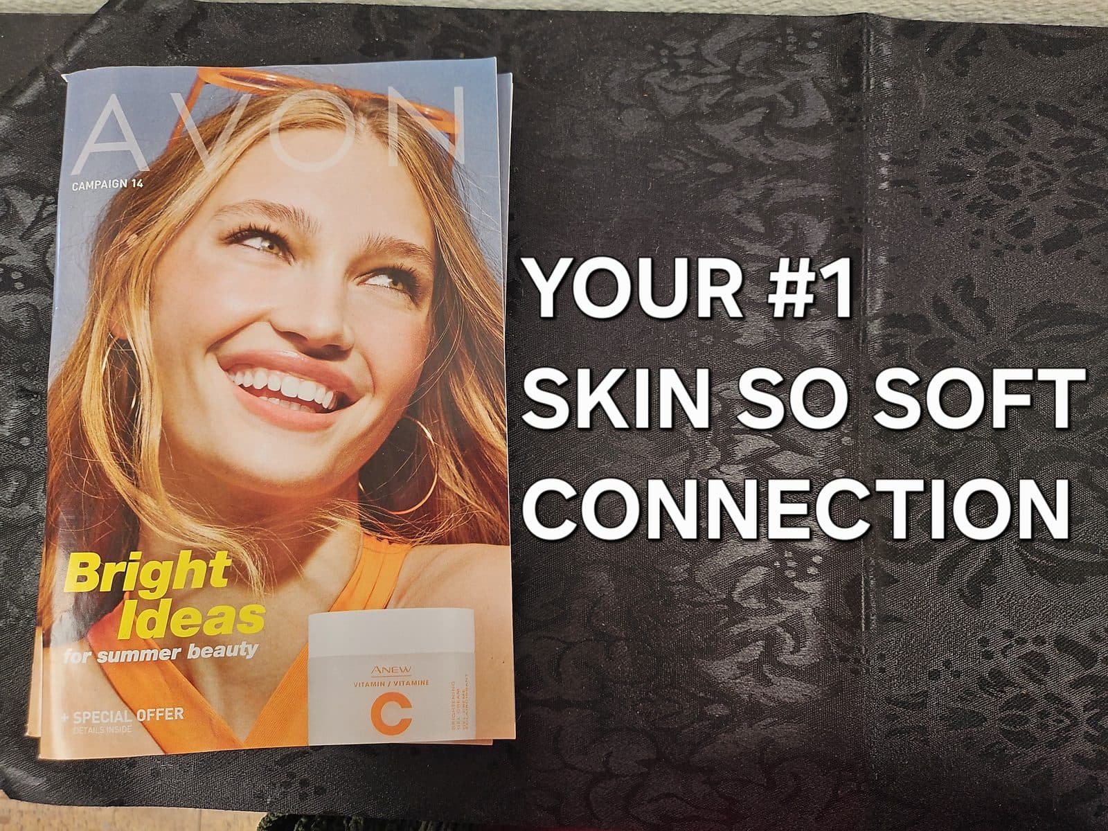 An Avon campaign brochure lying on a dark table, captioned “Your #1 Skin So Soft connection”.