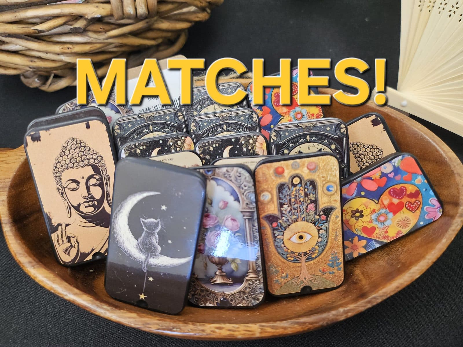Decorative matchbox tins in a wooden bowl, captioned “Matches!”.
